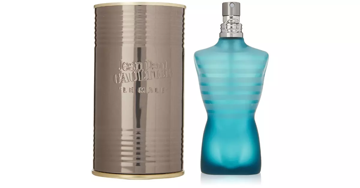 A box and bottle of Le Male Jean Paul Gaultier perfume are shown in the picture. The box is cylindrical in shape whereas the bottle is shaped like male torso and is light blue in color.