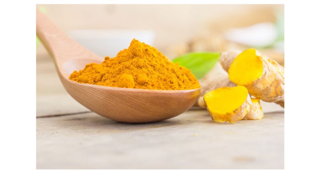 the picture shows powdered turmeric and cut ginger while writing informative article on does turmeric causes body odor